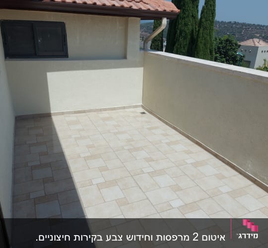 מרפסת מרוצפת עם קירות אטומים ופתח ניקוז
